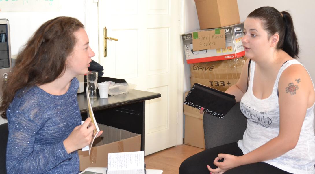 Teenage volunteer chat with each other about different interview techniques during their Journalism Project Journalism volunteers practice their interviewing skills as part of their project in Romania
